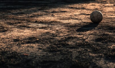Solitary Soccer Ball on Dusty Field at Sunset