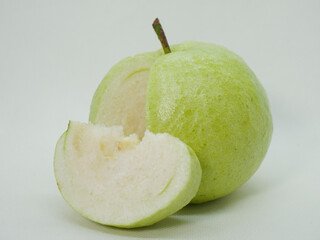 Cut Green Guava with Separate Slice &ndash; Fresh Tropical Fruit Displayed on Clean White Background for Healthy Food Concepts