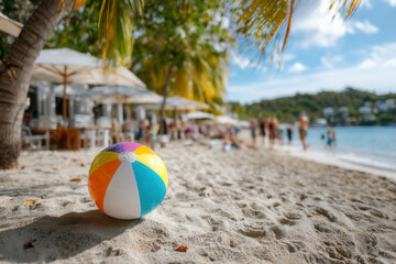 Obraz premium Colorful beach ball rests on soft sand, inviting playful days at a tropical Caribbean paradise