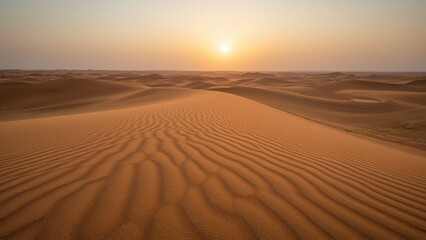 A stunning view of golden sand dunes at sunrise, capturing the serenity of the desert landscape as the sun rises above the horizon.