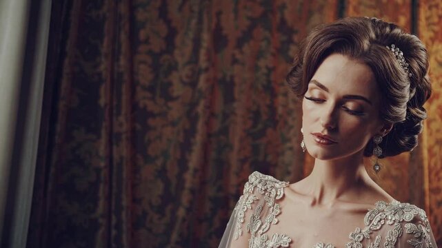 Elegance Unveiled: A woman with a refined demeanor is the central focus, her eyes closed and head tilted slightly downward. She is a picture of poise. Wearing fine attire.