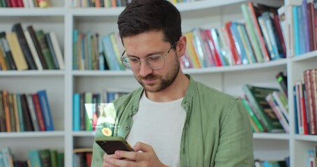 Bearded man in glasses using smartphone in chat dating app browsing internet social networks. Augmented reality dating concept.