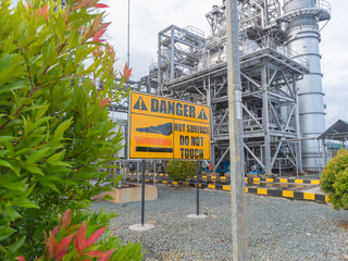 Danger signs reading "danger hot surfaces do not touch" in chemical, oil and gas, power plant, HRSG industrial areas