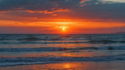 Fototapeta premium Stunning sunset with orange sky and ocean waves backdrop.