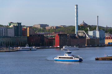 City skyline with ferry crossing Gota river in centre from Kvillepiren on sunny day in Gothenburg, Sweden