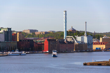 City skyline with ferry crossing Gota river in centre from Kvillepiren on sunny day in Gothenburg, Sweden
