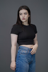 Plakat Trendy Young Woman in Casual Denim and Crop Top – Studio Portrait