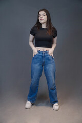 Plakat Trendy Young Woman in Casual Denim and Crop Top – Studio Portrait