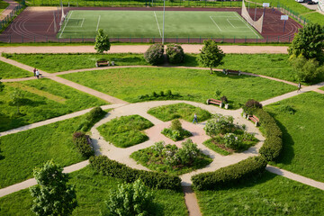 A stunning aerial view showcasing a vibrant green park equipped with multiple tennis courts