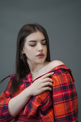 Plakat Stylish Woman in Red Maxi Skirt and Plaid Crop Top – Studio Fashion Portrait