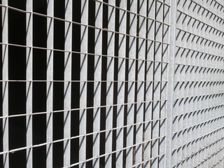 iron gate with rectangle shapes of shadow