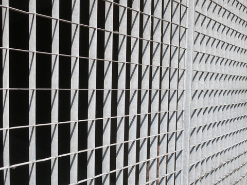 iron gate with rectangle shapes of shadow