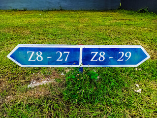 Closed up front view of road sign on a green grass