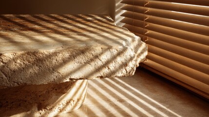 Natural stone table with sunlit window blinds for interior design inspiration