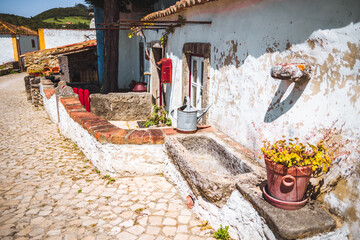 Quaint village scene in Aldeia da Mata Pequena featuring a whitewashed rustic house with a...