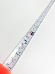 Black and orange measuring tape that can be stretched and held at a distance of 10 cm, measuring...