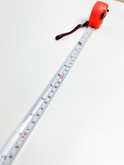 Black and orange measuring tape that can be stretched and held at a distance of 10 cm, measuring...