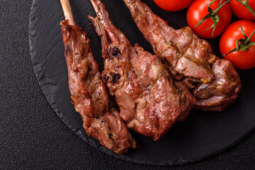Juicy meat on the bone or rack of lamb. Grilled veal with salt, spices and herbs