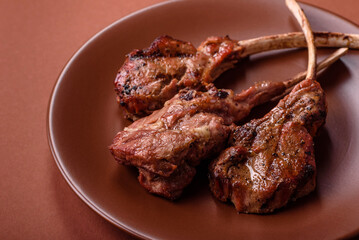 Juicy meat on the bone or rack of lamb. Grilled veal with salt, spices and herbs