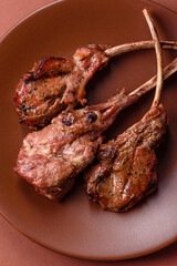 Juicy meat on the bone or rack of lamb. Grilled veal with salt, spices and herbs
