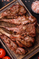 Juicy meat on the bone or rack of lamb. Grilled veal with salt, spices and herbs