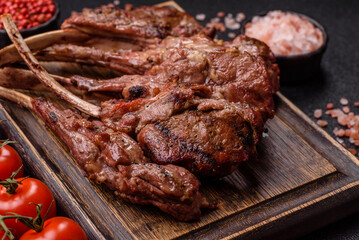Juicy meat on the bone or rack of lamb. Grilled veal with salt, spices and herbs