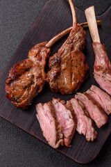 Juicy meat on the bone or rack of lamb. Grilled veal with salt, spices and herbs