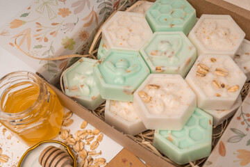 Handmade small honeycomb oatmeal and honey soaps bars in box. Aesthetic soap on white background with copy space
