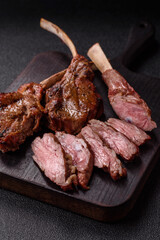 Juicy meat on the bone or rack of lamb. Grilled veal with salt, spices and herbs