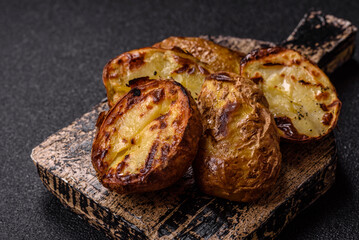 Food, potatoes cut in halves or slices grilled. Cooked baked potatoes