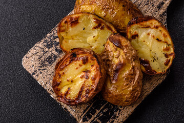 Food, potatoes cut in halves or slices grilled. Cooked baked potatoes