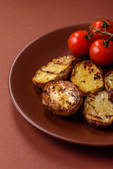 Food, potatoes cut in halves or slices grilled. Cooked baked potatoes