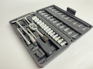 Great studio shot of various tools, socket wrenches arranged in a box.