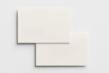 Two white cards are placed on a white background. The cards are blank and have no writing on them