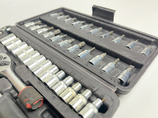 Great studio shot of various tools, socket wrenches arranged in a box.