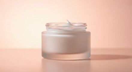 Frosted cosmetic jar on peach gradient background with soft glowing light