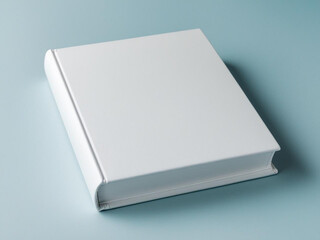 Blank white book on light blue background.