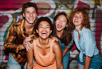 Friends going out in the evening and making party. Young people meeting outdoor in the weekend and celebrating together.
