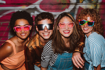 Friends going out in the evening and making party. Young people meeting outdoor in the weekend and celebrating together.