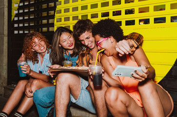 Friends going out in the evening and making party. Young people meeting outdoor in the weekend and...