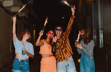 Friends going out in the evening and making party. Young people meeting outdoor in the weekend and celebrating together.