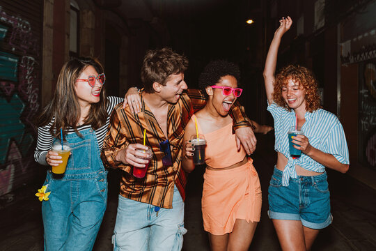 Friends going out in the evening and making party. Young people meeting outdoor in the weekend and celebrating together. - Powered by Adobe