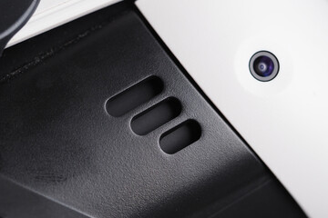 Close-up view of a VR headset with ventilation slots and a camera lens.