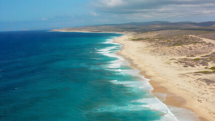Vast shoreline revealing beauty of ocean waves and sandy beaches under clear blue skies