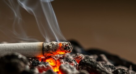 Burning Cigarette in Ashtray - Close-up of a burning cigarette in an ashtray, with smoke rising. Depicts the dangers of smoking