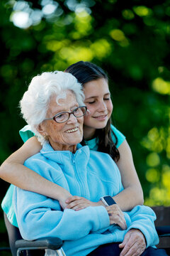Elderly woman enjoying an embrace outdoors