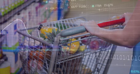 Shopper wearing T-shirt loading cart with pineapple and greens in store aisle, digital overlay