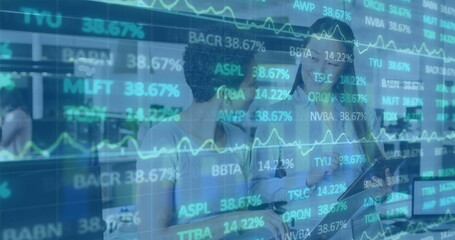 Image of financial graphs and data over diverse female coworkers in office