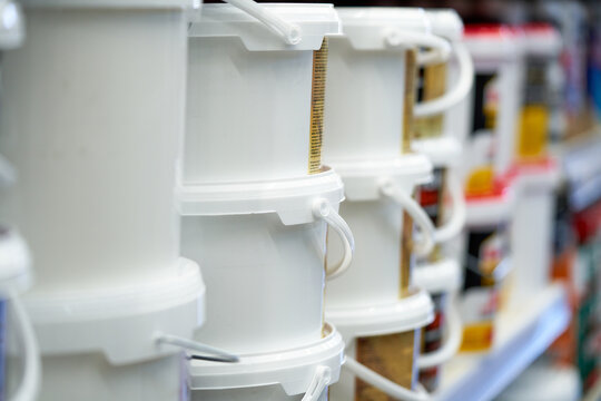 Paint cans on store shelf in a construction supply store