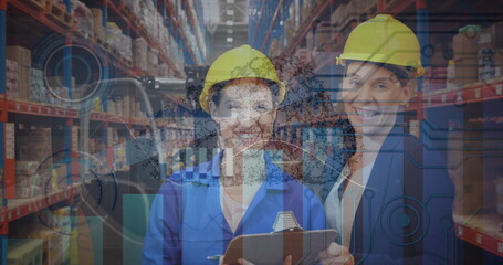 Image of graphs and data over happy caucasian female warehouse workers